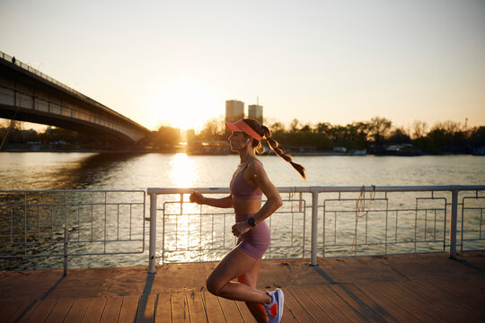 Fit woman running beneath the bridge