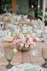 a large flower arrangement on a wooden table is pictured at an event