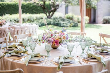 white and green table setting with floral arrangements for a wedding reception