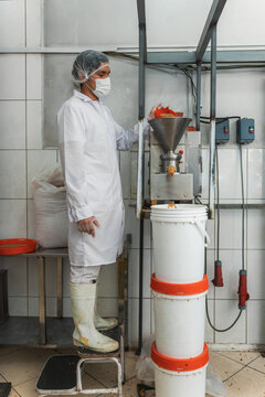 Man Processing Peanuts into Butter