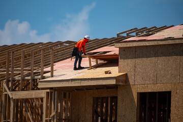 Roofing construction. Roofer roofing on roof structure. Roofing Wooden House Frame. Worker roofer...