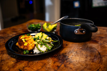 a pan and two plates with food on a table near a bowl