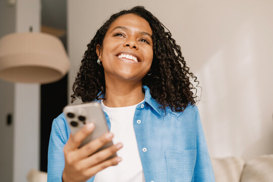 Cheerful Young Adult Texting at Home