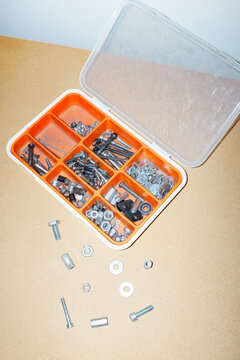 Toolbox with shiny silver metallic nut. screw, pound with flashlight
