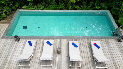 Vacant beach chairs face an above-ground swimming pool in Prince Island, Sao Tome, Africa