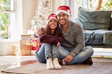 Christmas, portrait and happy couple hug in home for festive holiday, love and bonding in living...