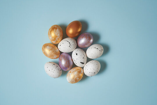 Various Easter eggs on bright blue background. 