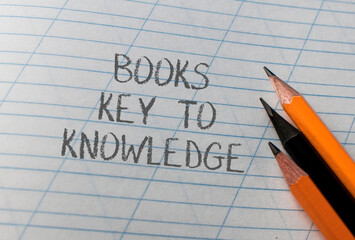 A piece of paper with the words books key to knowledge written on it