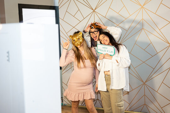 Friends having fun at party photo booth.