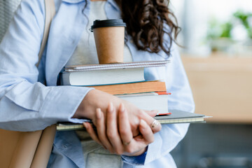 A student with textbooks in the classroom