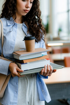 A student with textbooks in the classroom