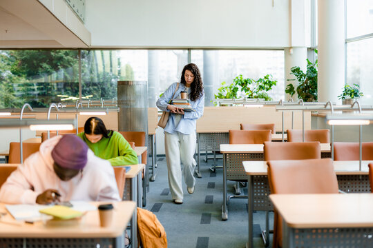 A student with textbooks in the classroom