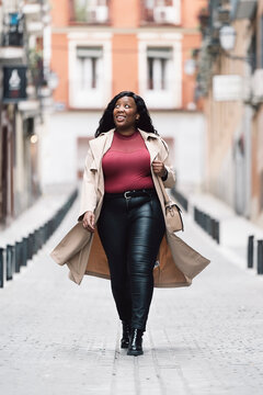 Confident woman walks happily through the city