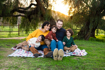 Lifestyle Family Portrait of Young Family Smiling Together at Sunset