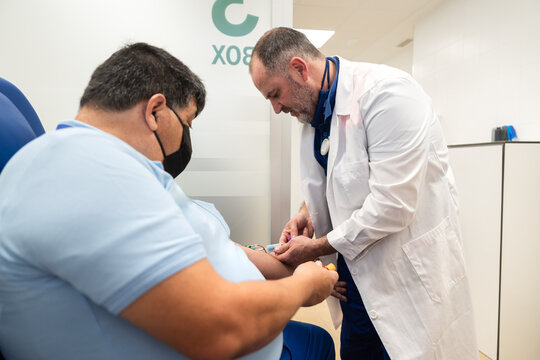 Doctor administering vaccine to patient