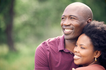Fototapeta premium Black couple, happy and hug outdoor in park with love for relationship, romance and commitment. Smiling, man and woman embrace in nature for relaxing, dating fun and bonding on weekend adventure