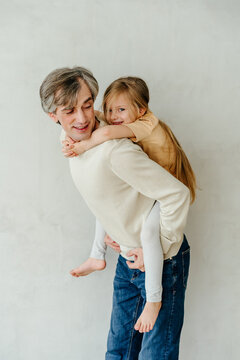 Father carrying daughter on his back