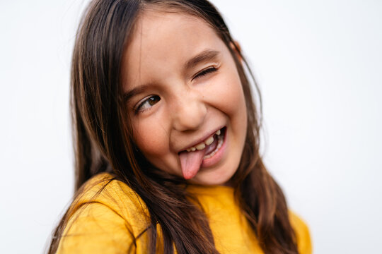 Happy Young tween Girl Playfully Sticking Out Tongue
