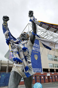 Statue of Leeds United player Billy Bremner draped in fans scarves celebrating outside their ground at Elland Road. Leeds, UK 05 23 2024