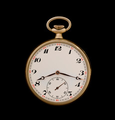 A gold vintage pocket watch on a black background