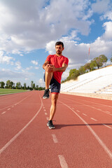 Fototapeta premium Athlete warming up by stretching before exercise. man doing stretching exercises before exercise