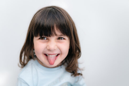 Playful Young Girl Sticking Out Tongue