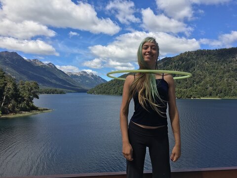 Hula hoop performed by a young woman in nature