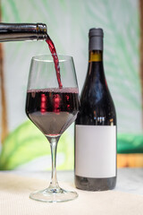 the wine is pouring into the glass to be poured into