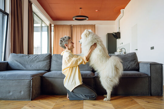 A woman with a dog indoors