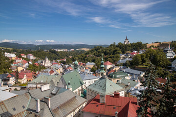 Fototapeta premium City roofs with mountain range backdrop in Banska Stiavnica in Slovakia