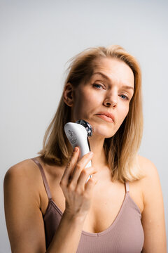 A woman does a facial massage