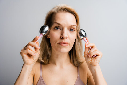 A woman does a facial massage