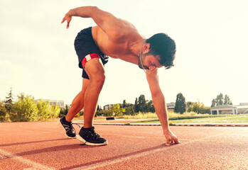 Stadium, man running and start block of athlete on a runner and arena track for sprint