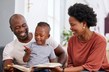 Parents, boy and book for coloring in home, creative and support in learning for child development. Black family, son and crayons for art in homework, education and drawing together for project
