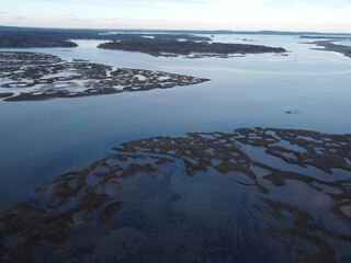 a view of an ocean from an airplane above water and land