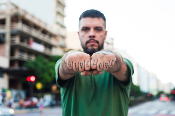 Man with a tattoo with the message give love
