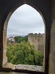 Fototapeta premium a very old arch view out over a castle wall with an island in the background