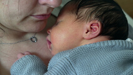 Newborn baby resting on mother's chest during first week of life, infant's initial days of life...