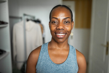 portrait of black woman wearing sportswear at home