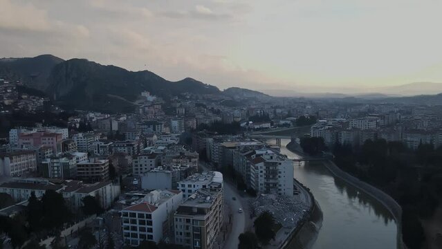 Drone of Hatay revealing river, trees, mountain, houses and collapsed buildings after the earthquake