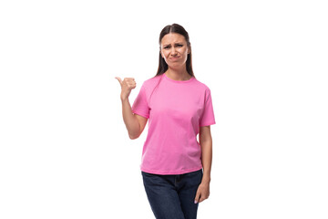 young positive good-looking woman with black hair is wearing a pink t-shirt holding her hand up