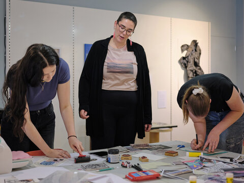 Art teacher instructing students at art class