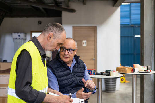Business leader and employee in warehouse