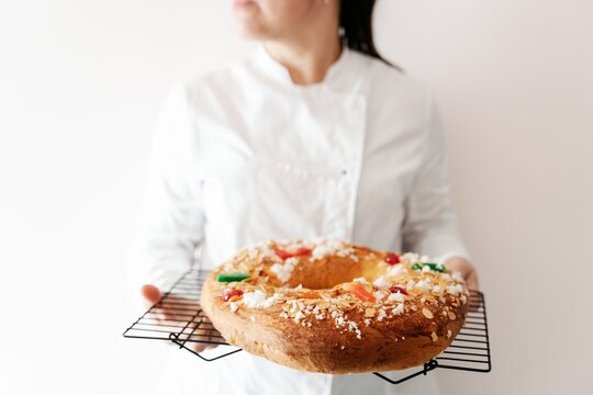 Pastry chef presenting freshly baked cake