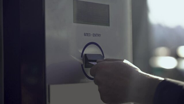 Close-up Of Person's Hand taking ticket into parking machine to pay for parking