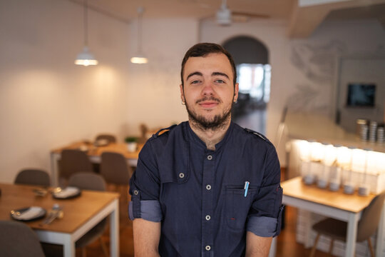 portrait of young waiter in a restaurant