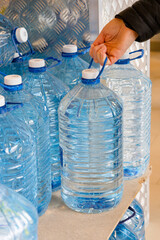 In their hand, a person holds a bottle filled with water