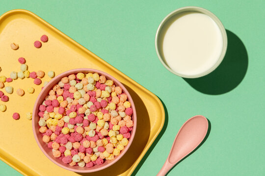 Colorful ball-shaped pop breakfast cereal on blue background