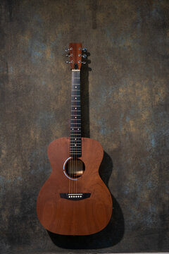 Guitar  near wall.
