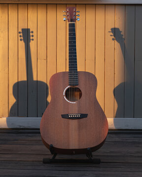 Guitars  on outdoor wooden  exterior.
